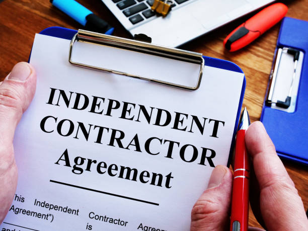 istock Man is signing Independent contractor agreement by pen. 1212674667