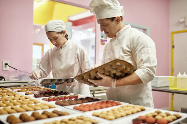 istock Bakers in 30s and 40s Preparing Vegan Cupcakes for Icing 1212674692