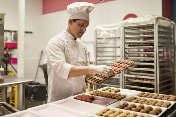 istock Mature Hispanic American Male Chef Baking Vegan Cupcakes 1212674698