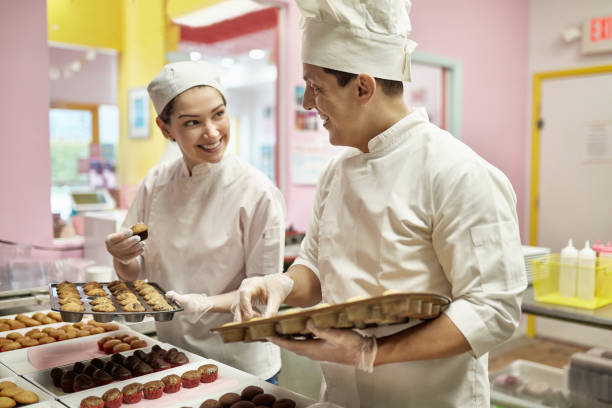 istock Smiling Hispanic Bakers Satisfied with Their Vegan Cupcakes 1212674749