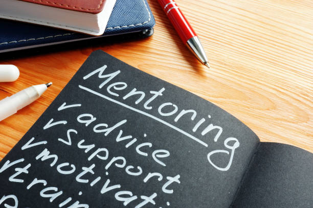 istock Mentoring with mentor list advice, support and motivation in the notepad. 1212674762