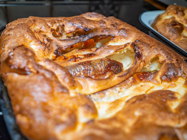 istock Close up of a traditional British Toad in the Hole sausage and batter dinner 1212674767