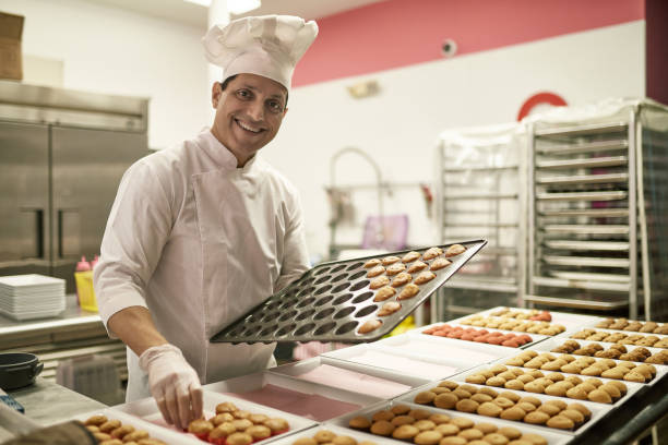istock Mature Hispanic American Chef Preparing Cupcakes for Icing 1212674769