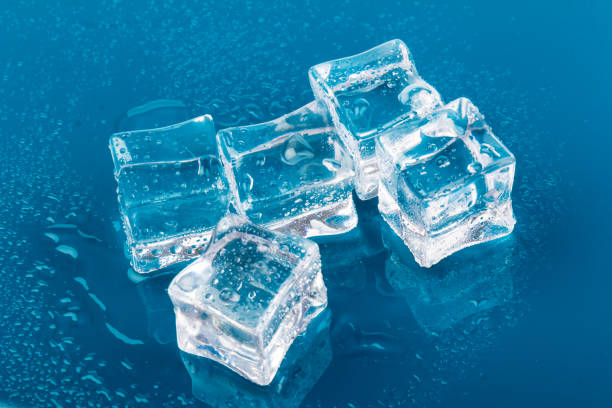 istock ice cubes and water drops close up on blue background 1212675125