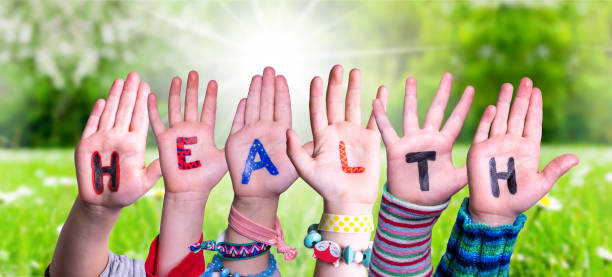 istock Children Hands Building Word Health, Grass Meadow 1212676621
