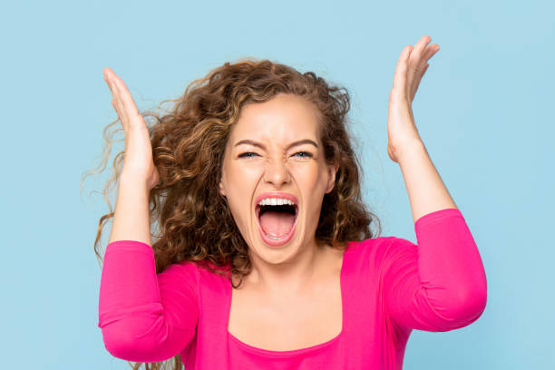istock Shocked angry young Caucasian woman shouting isolated on light blue studio background 1212677187
