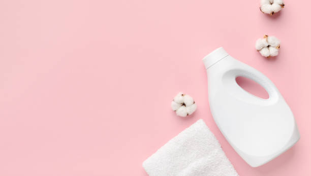 istock Laundry detergent bottle with fabric softener isolated on pink 1212677263