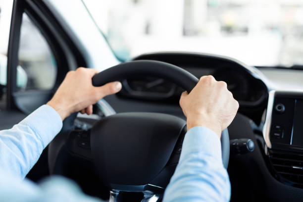 istock Man Holding Steering Wheel Sitting In Auto 1212678276