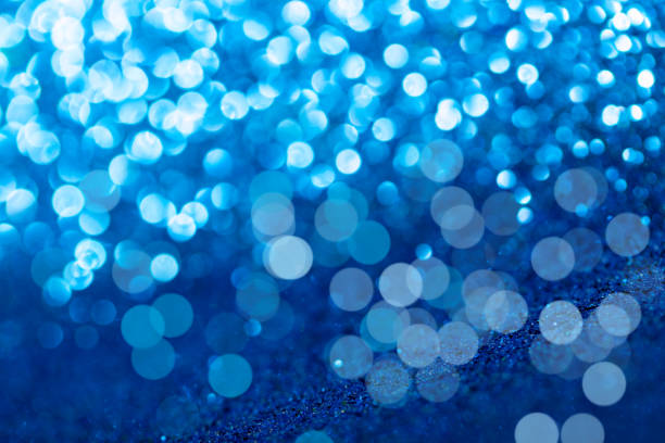 istock Blue glitter foil background. Shiny metal blue foil texture abstract defocused background. Sparkle glitter texture with bokeh lights 1212678333