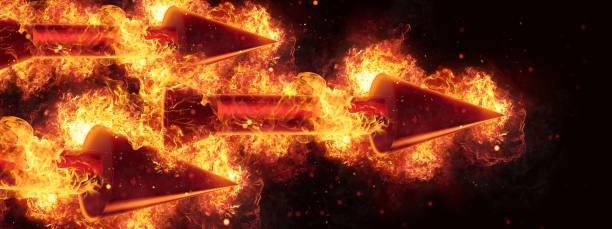 istock Red arrows wrapped in flames flying in the dark 1212679576
