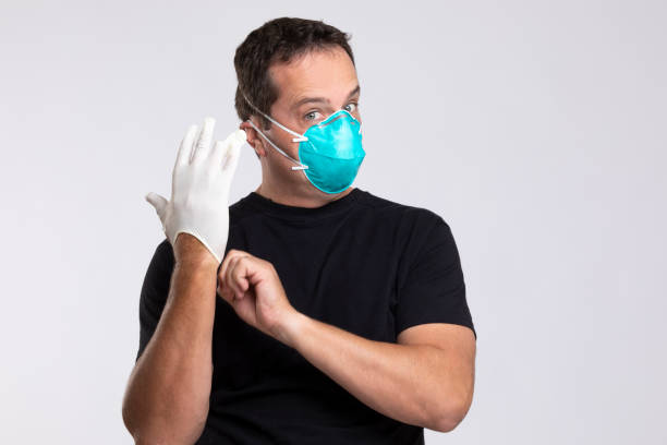 istock Man putting on latex gloves. 1212682712