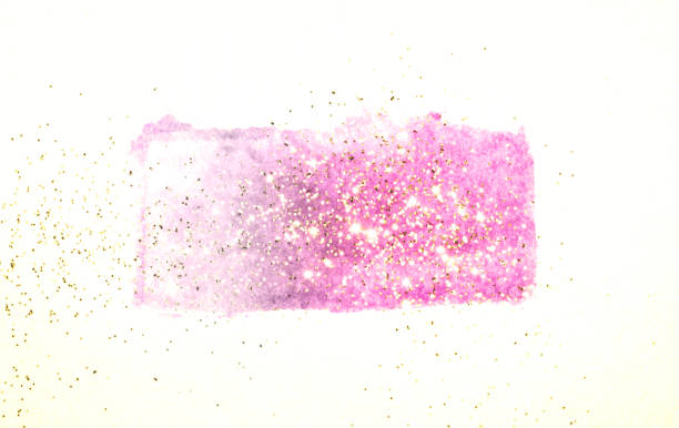 istock Golden glitter on abstract pink watercolor splash on white 1212684859