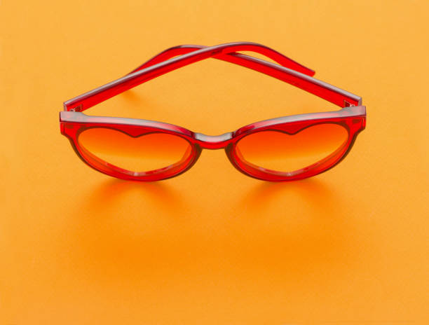 istock red sunglasses on yellow background 1212686265