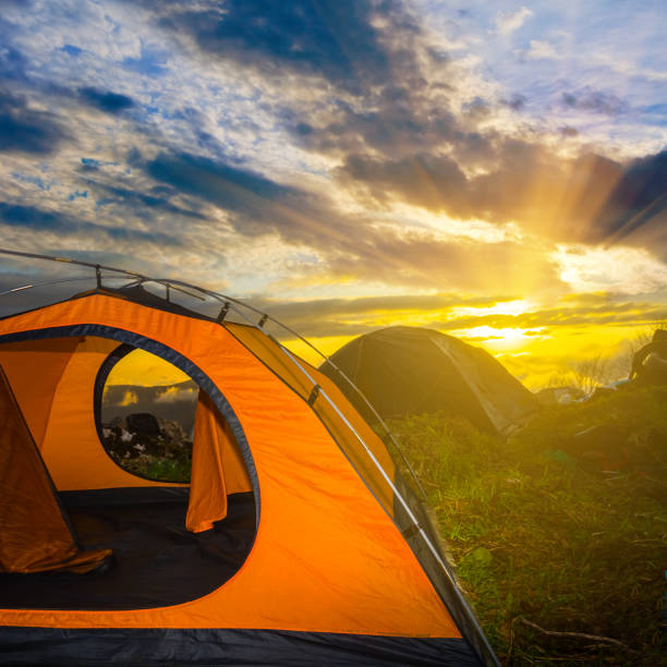 istock orange touristic tent on a sunset background 1212686270