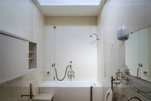 istock Beautiful shower bath tub in modern functionalism bathroom, white tile design wall 1212686547