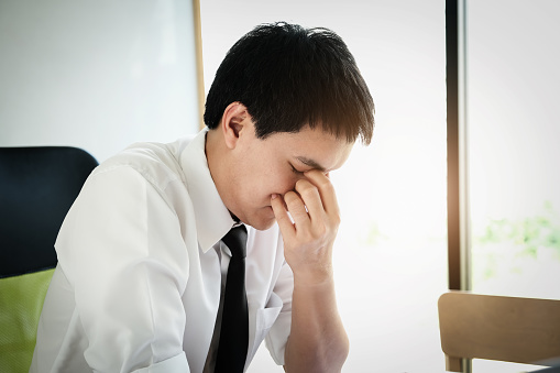 male employees show headaches from work or disappointment from work. Health and care concept