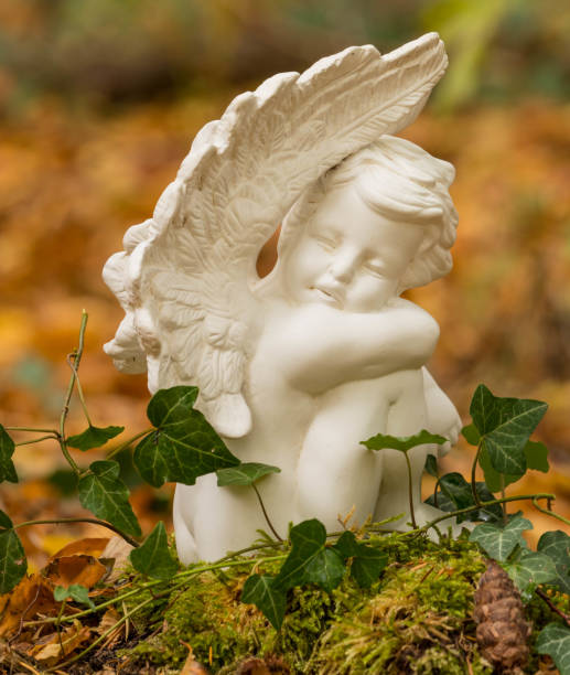 istock Urn grave with angel, forest cemetery 1212688659