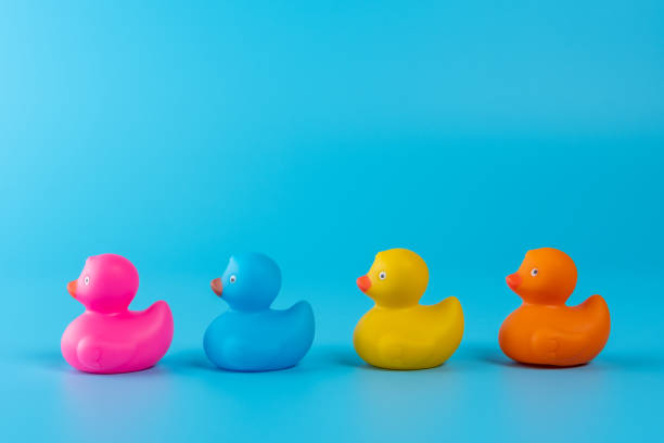 istock Colorful rubber ducks on blue background. Summer minimal concept. 1212688994