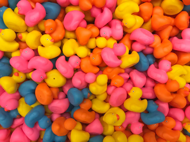istock Creative background with colorful rubber ducks. Minimal holiday concept. 1212689043