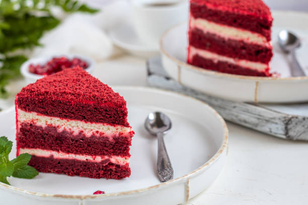 istock Cake Red velvet on two white plates, two servings. On a light background. Birthday, holidays, sweets. 1212689044