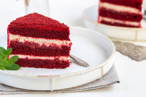 istock Cake Red velvet on two white plates, two servings. On a light background. Birthday, holidays, sweets. 1212689048