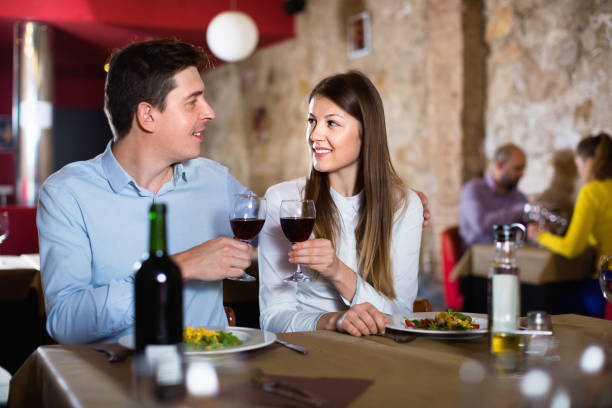 istock Loving pair enjoying evening meal and conversation at cozy restaurant 1212689494