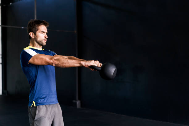 istock Determined male exercising in gym 1212689616