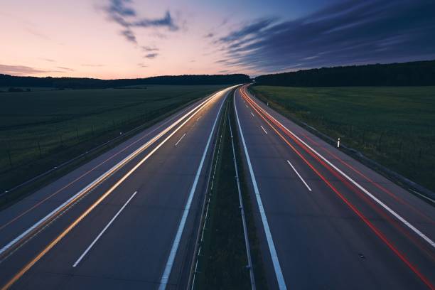 istock Light trails of cars on highway 1212690249