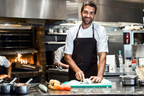 istock Confident male chef preparing food in restaurant 1212690650