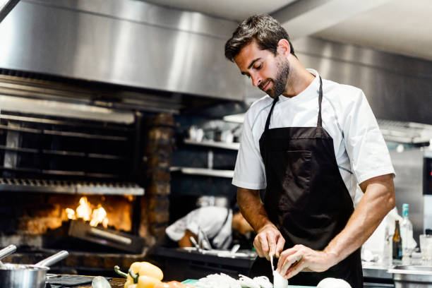 istock Male chef preparing food in commercial kitchen 1212690810