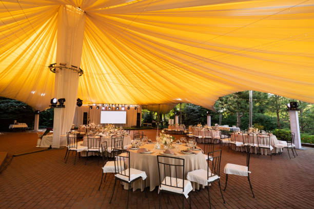 istock tables in outdoor tent day. Wedding decor. 1212690935