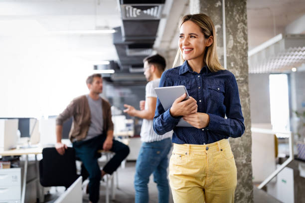 istock Portrait of a smiling designer, student, freelancer business woman using tablet computer 1212692094