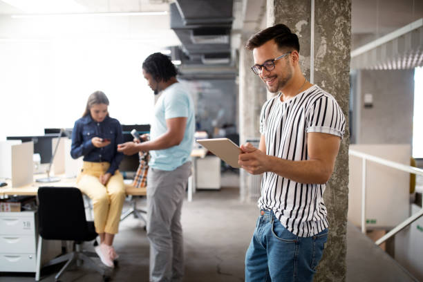 istock Young man using technology, digital tablet in corporate business office 1212692149