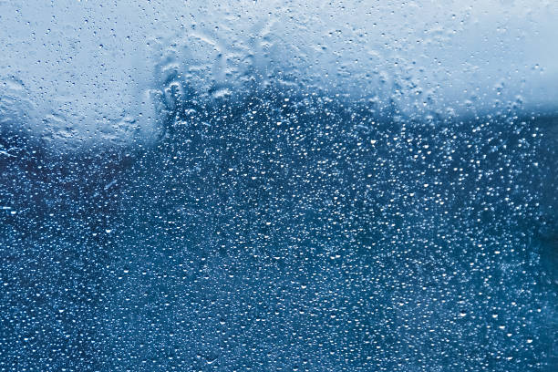 istock blue color frozen snowflakes winter window background 1212692486