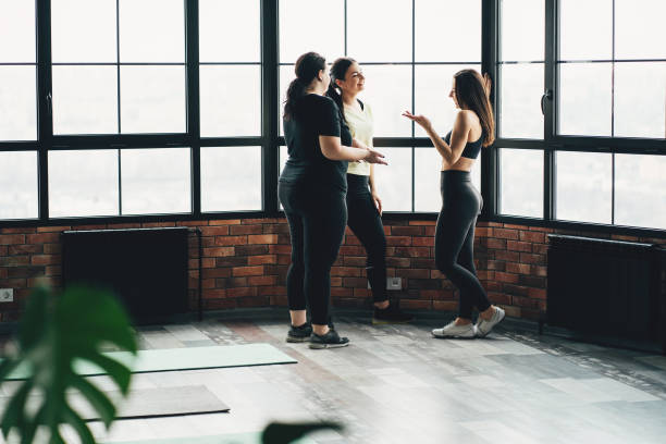 istock Cheerful women talking before workout at the gym 1212692647