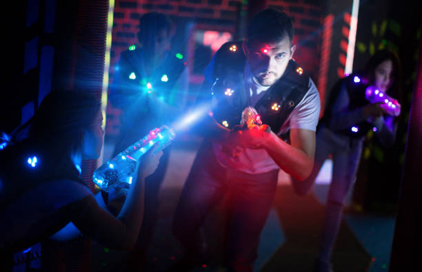 istock Emotional guy playing laser tag in colorful beams 1212692892