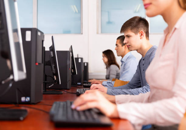 istock Side view of coworkers during daily work at computers in office 1212693244