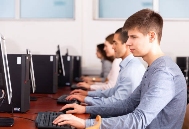 istock Side view of coworkers during daily work at computers in office 1212693250