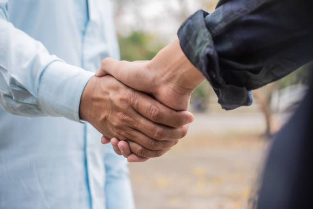 istock Close up friends shake hands friendship partner community 1212693299