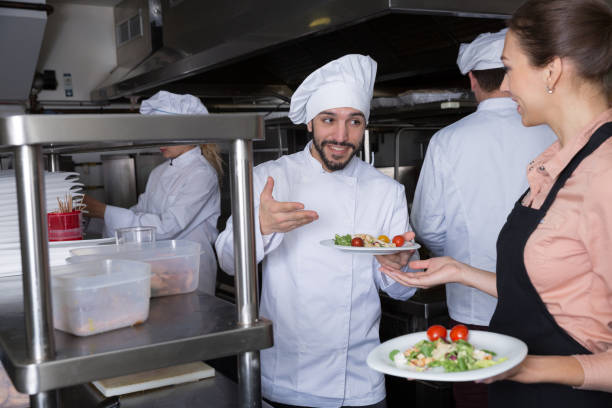 istock Chef with team preparing food 1212693369