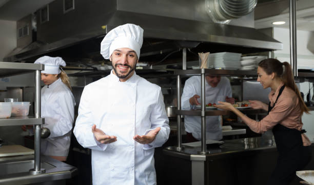 istock Glad chef of restaurant posing in kitchen 1212693374