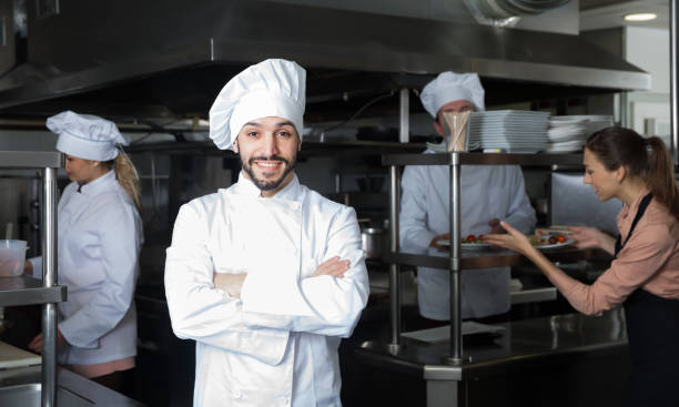 istock Adult chef of restaurant posing in kitchen 1212693384