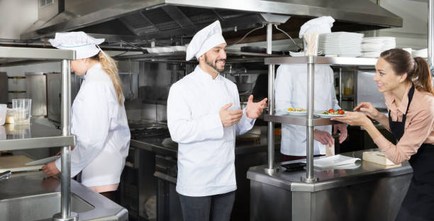 istock Chef checking dishes in kitchen of restaurant 1212693387