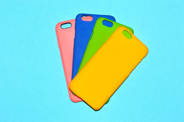 Colorful phone cases isolated on blue background stock photo