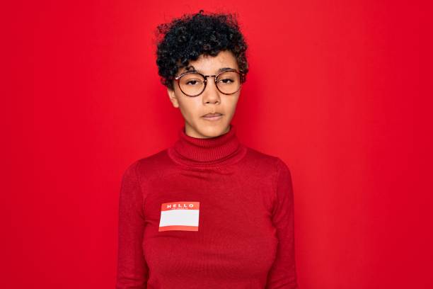 istock Young beautiful african american afro woman using sticker with presentation message with a confident expression on smart face thinking serious 1212693474