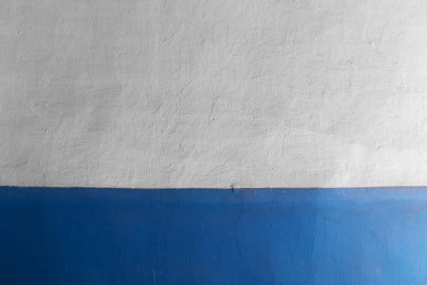 istock Concrete plastered wall painted in white and blue 1212694699