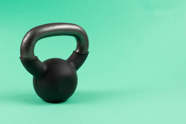 istock Black weight on green background. 4 kg weight. 1212694856