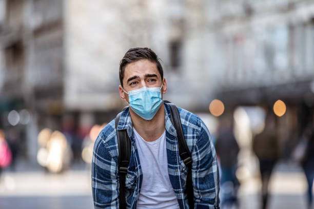 istock Man Wear Face Mask And Coughing While Standing In The Town 1212698277