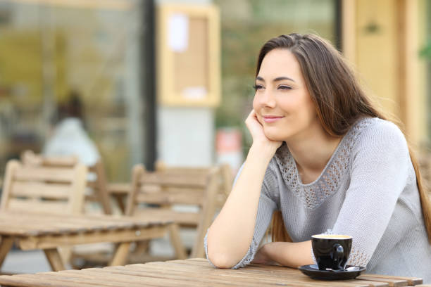 istock Confident woman looking away sitting on a terrace 1212698743