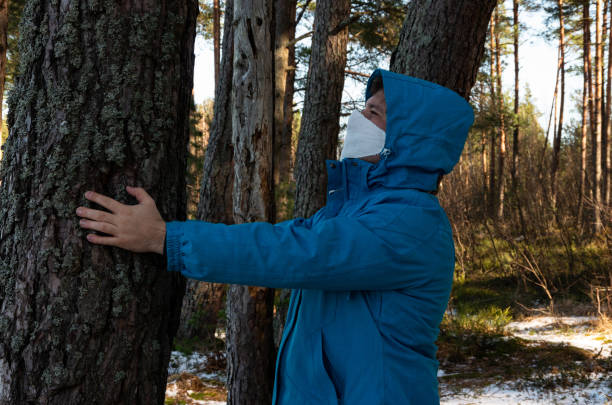 istock Virus, a man with a white face mask in a blue jacket 1212698967